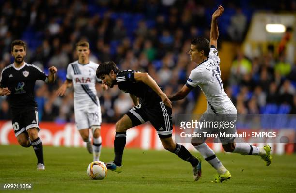 Tottenham Hotspur's Erik Lamela is tackled by Qarabag's Afran Ismayilov