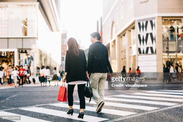 couple crossing the street - aichi prefecture stock pictures, royalty-free photos & images