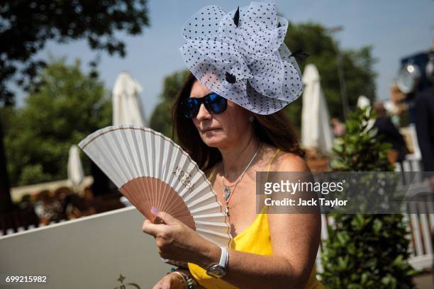 Racegoer fans herself as she attends Royal Ascot 2017 at Ascot Racecourse on June 21, 2017 in Ascot, England. The five-day Royal Ascot meeting is one...