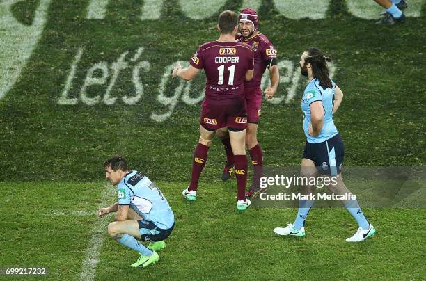 Johnathan Thurston of the Maroons celebrates victory with team mate Gavin Cooper during game two of the State Of Origin series between the New South...