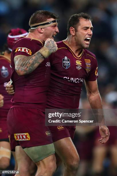 Maroons captain Cameron Smith and team mate Josh McGuire celebrate winning game two of the State Of Origin series between the New South Wales Blues...