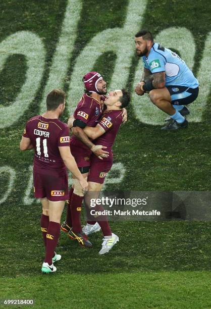 Johnathan Thurston of the Maroons celebrates victory with team mates Billy Slater and Gavin Cooper during game two of the State Of Origin series...