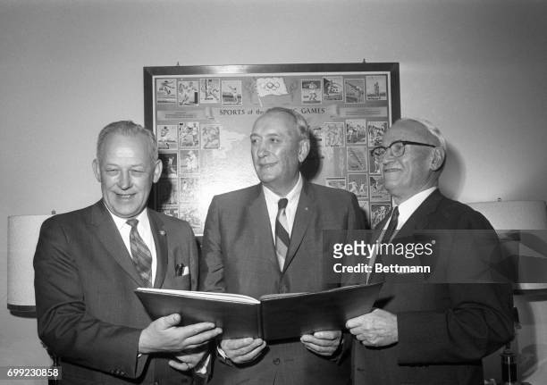 Mayor Terry Schrunk and Pacific Power and Light Co. Board Charmian Paul B. McKee show U.S. Olympic Committee President Kenneth Wilson why they think...