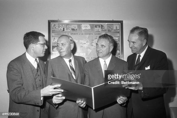Three-man delegation from San Francisco shows U.S. Olympic Committee Kenneth Wilson makes a request for the 1968 Summer Olympics, as committee meets...