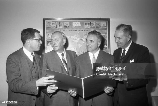 Three-man delegation from San Francisco shows U.S. Olympic Committee Kenneth Wilson makes a request for the 1968 Summer Olympics, as committee meets...