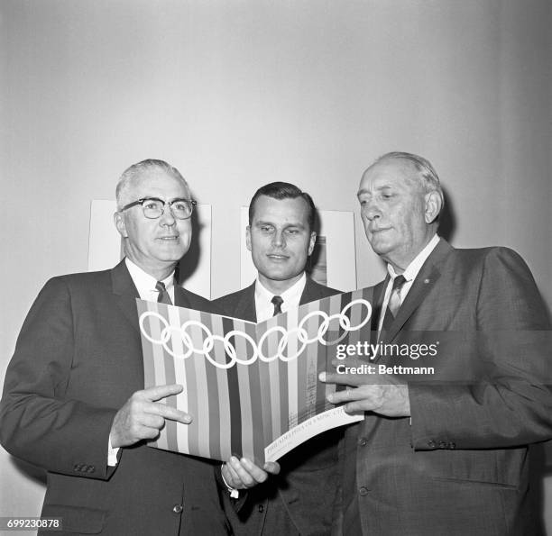 Mayor James H.J. Tate of Philadelphia and four-time Olympic oarsman John B. Kelly Jr. , brother of Princess Grace of Monaco, show prospectus on their...