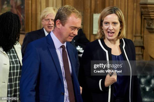 Britain's Home Secretary Amber Rudd talks with outgoing leader of the Liberal Democrats Tim Farron as they walk across the Central Lobby of the...