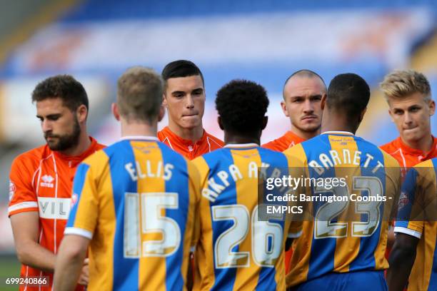 Blackpool's Clark Robertson, Lloyd Jones, Tom Aldred and Brad Potts shake hands with the Shrewsbury Town players before the game