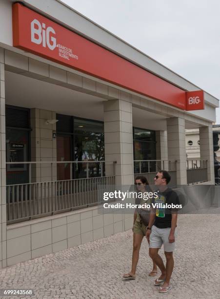 People walk by the BiG-Banco de Investimento Global branch on June 21, 2017 in Estoril, Portugal. Big won a litigation after the Lisbon Court of...