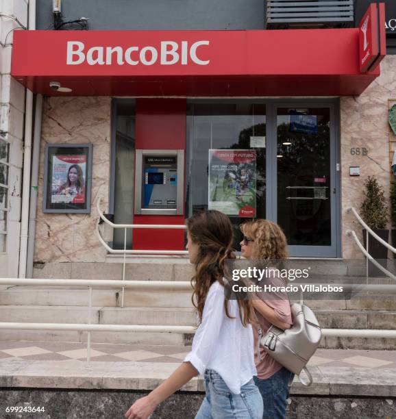 People walk by the BiG-Banco de Investimento Global branch on June 21, 2017 in Estoril, Portugal. Big won a litigation after the Lisbon Court of...