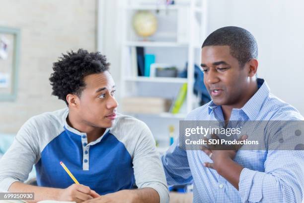 vulnerable father talks seriously with son - dad advice stock pictures, royalty-free photos & images