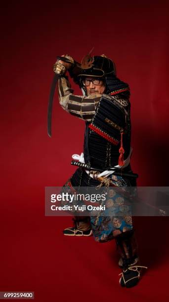 samurai wearing glasses with armor setting sword - samurai sword stock pictures, royalty-free photos & images