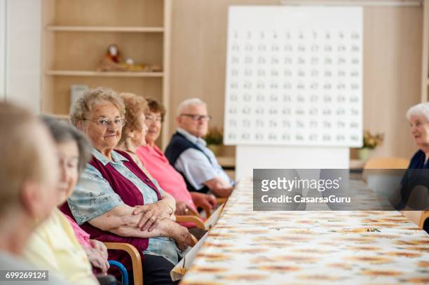 seniors in dining room of the retiremen home waiting - retiremen stock pictures, royalty-free photos & images