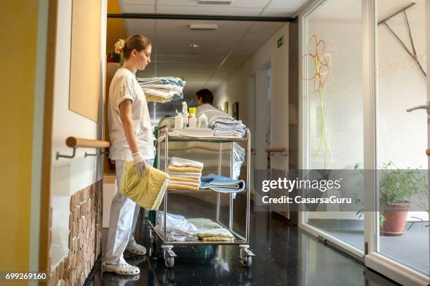 nurse changing laundry in the nursing home - carrying laundry stock pictures, royalty-free photos & images