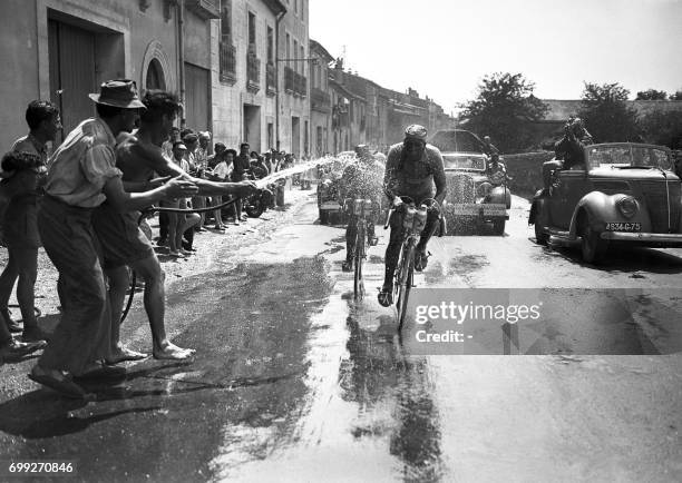 Abdel-Kader Zaaf, on the left, and Marcel Molinès, both of the same team "North Africa", pedal side by side during the 13th stage of the 37th Tour de...