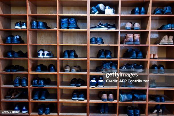 Shoes are pictured in a storage rack as Scotland's First Minister and Scottish National Party leader Nicola Sturgeon meets worshippers during a visit...