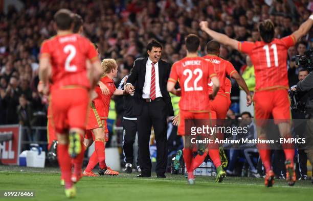 Wales' players celebrate with manager Chris Coleman after Aaron Ramsey scores his side's first goal of the game