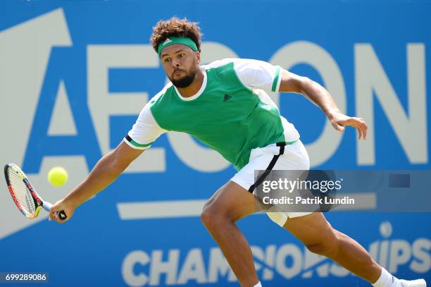 Jo-Wilfried Tsonga of France hits a forehand during the 2nd round match against Gilles Muller of Luxemburg on day three at Queens Club on June 21,...