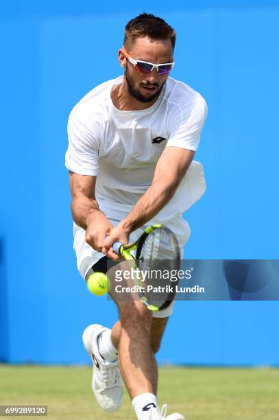 Viktor Troicki of Serbia reach for a backhand during the 2nd round match against Donald Young of the United States at Queens Club on June 21, 2017 in...