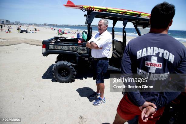 Jimmy Donahue, left, who has been working at Hampton Beach in Hampton, NH for 57 years lifeguarding, stands on the beach with Lifeguard Nicholas...