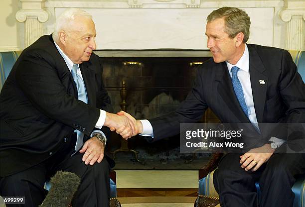 Israeli Prime Minister Ariel Sharon shakes hands with U.S. President George W. Bush February 7, 2002 during their meeting at the Oval office of the...