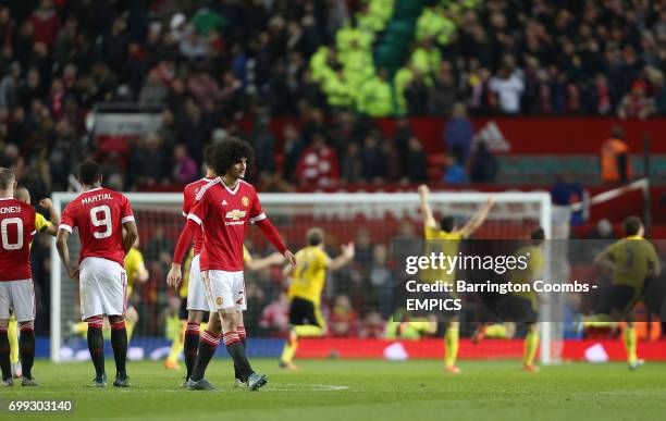 Manchester United's Marouane Fellaini looks dejected as Middlesbrough players run to celebrate winning on penalties
