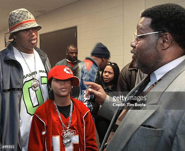 Rappers Master P and Lil Romeo talk with the principal of Orr High School Leo Hudnall February 7, 2002 in Chicago, IL. The singers came to the school...