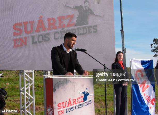 Uruguayan footballer Luis Suarez speaks during the inauguration of a football pitch with his name at Los Cespedes' Nacional team sport complex in...