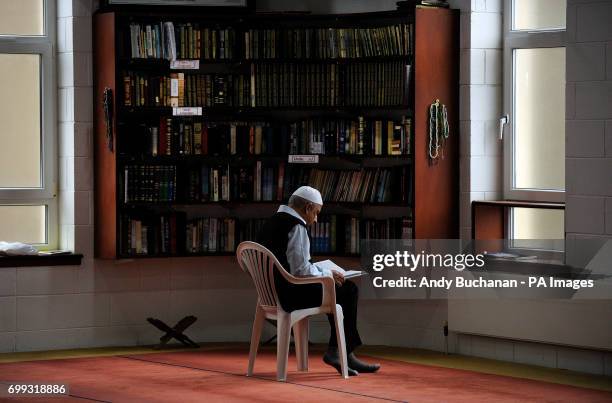 Man reads as Scotland's First Minister Nicola Sturgeon meets worshippers during a visit to Dundee Central Mosque in Dundee.