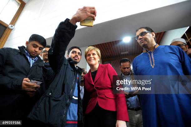 Scotland's First Minister and Scottish National Party leader Nicola Sturgeon poses for a "selfie" photograph as she meets worshippers during a visit...