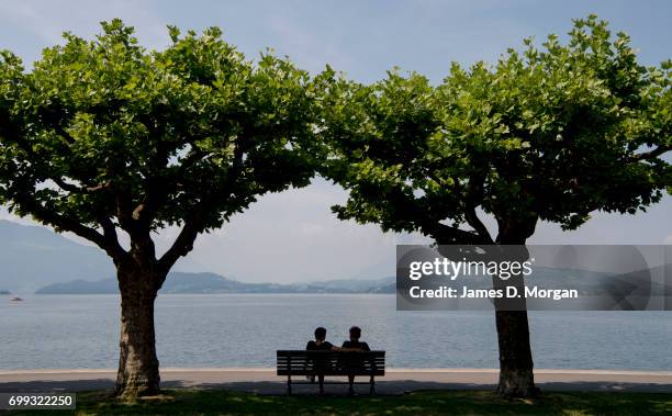 Couples seek shade beside the lake on the longest day of 2017 on June 21, 2017 in Zug, Switzerland. The summer solstice was celebrated in the...