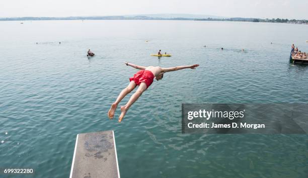 Young boys diving into the lake during the longest day of 2017 on June 21, 2017 in Zug, Switzerland. The summer solstice was celebrated in the...
