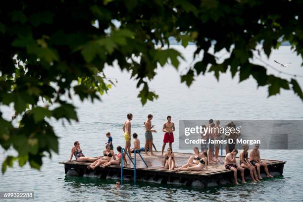 Locals on a pontoon enjoying the hot weather on the longest day of 2017 on June 21, 2017 in Zug, Switzerland. The summer solstice was celebrated in...