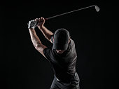 Dramatic Image Of A Male Golfer At The Top Of His Swing