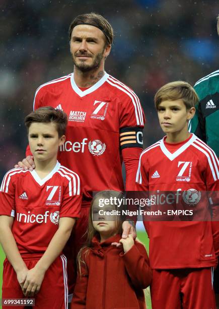 Great Britain and Ireland's captain David Beckham with his children, Romeo , Cruz and Harper before the game against Rest of the World.