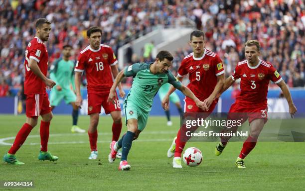 Cedric of Portugal attempts to shoot while he is closed down by the Russia defence during the FIFA Confederations Cup Russia 2017 Group A match...