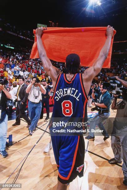 Latrell Sprewell of the New York Knicks holds up a towel to the fans as he walks off the court after the 2000 NBA Eastern Conference Semifinals...