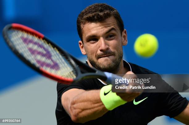 Grigor Dimitrov of Bulgaria hits a forehand during the 2nd round match against Julien Benneteau of Franceon day three at Queens Club on June 21, 2017...