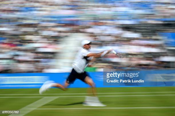 Julien Benneteau of France runs for a volley during the 2nd round match against Grigor Dimitrov of Bulgaria on day three at Queens Club on June 21,...