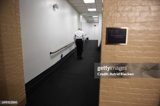 Rep. Roger Williams , who suffered a leg-ankle injury during last week's shooting during the congressional baseball practice, moves on crutches to a...