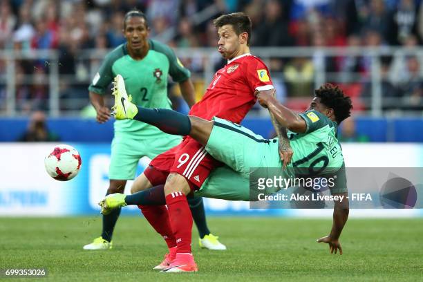 Fedor Smolov of Russia and Eliseu of Portugal battle for possessin during the FIFA Confederations Cup Russia 2017 Group A match between Russia and...