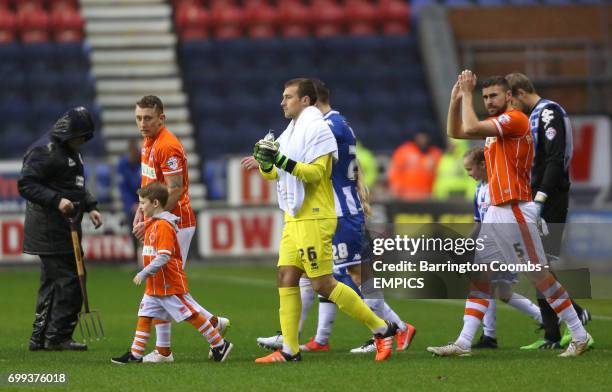 Wigan Athletic and Blackpool players walk out onto the pitch ahead of kick off