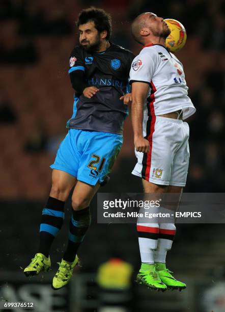 Milton Keynes Dons' Samir Carruthers and Sheffield Wednesday's Alex Lopez battle for the ball
