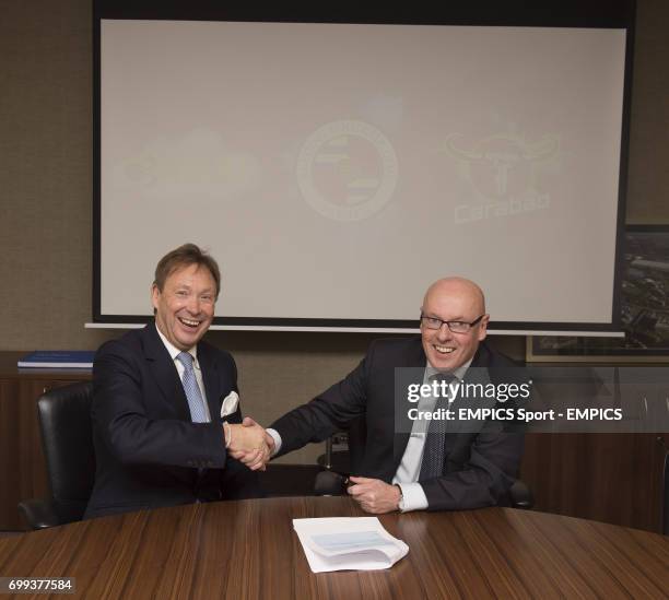 Reading FC Chief Executive Nigel Howe looks on as new manager Brian McDermott signs his contract prior to a press conference at the Madejski Stadium,...