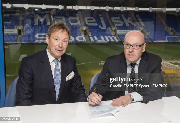 Reading FC Chief Executive Nigel Howe looks on as new manager Brian McDermott signs his contract prior to a press conference at the Madejski Stadium,...