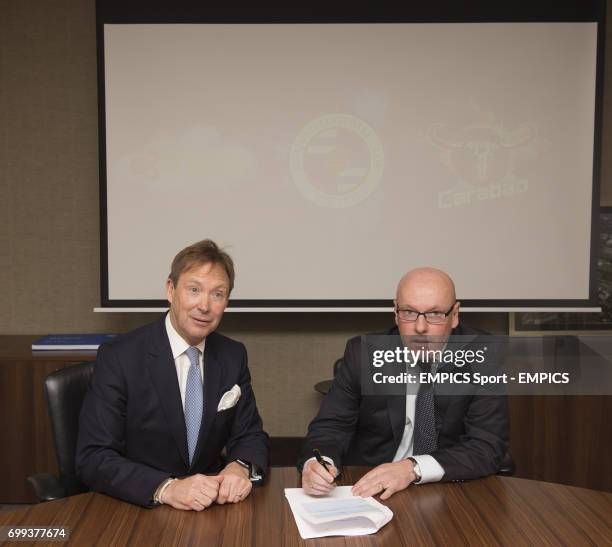 Reading FC Chief Executive Nigel Howe looks on as new manager Brian McDermott signs his contract prior to a press conference at the Madejski Stadium,...