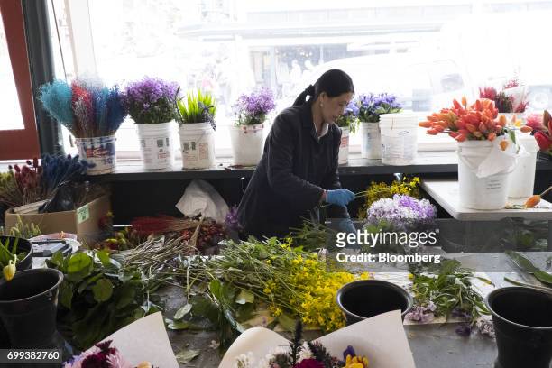 Vendor makes flower bouquets inside the Pike Place Market in Seattle, Washington, U.S., on Wednesday, May 17, 2017. Bloomberg is scheduled to release...