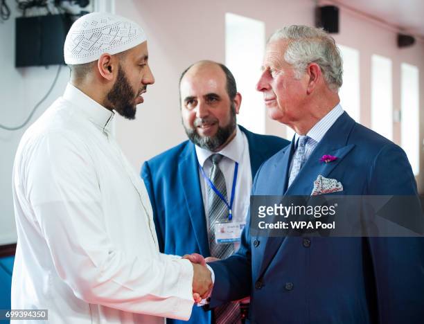Toufik Kacimi, CEO of Muslim Welfare House looks on as Prince Charles, Prince of Wales shakes hands with Imam Mohammed Mahmoud who protected the...