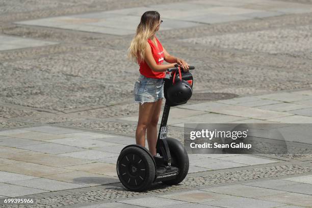 Young woman rides on a Segway on June 20, 2017 in Berlin, Germany. Segways have become increasingly popular in big cities, particularly for tourists.