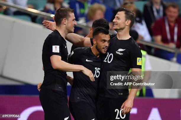 New Zealand's forward Chris Wood celebrates with New Zealand's midfielder Clayton Lewis and New Zealand's defender Tommy Smith after scoring a goal...